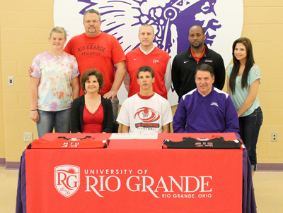 Logan High's Anthony McNeal is joined by family and coaches for a photo after signing to play at Rio Grande